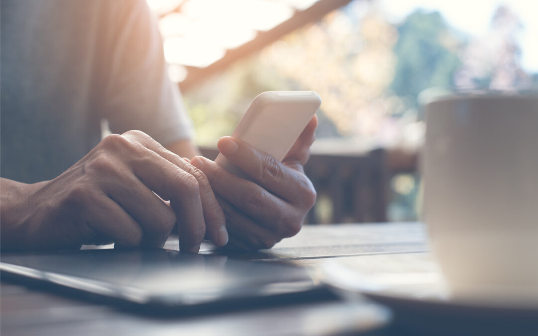 Looking at phone with coffee